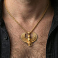 Load image into Gallery viewer, Sterling silver winged cat pendant worn on the neck, close-up lifestyle photo featuring the gold plated finish and wide feathered wings
