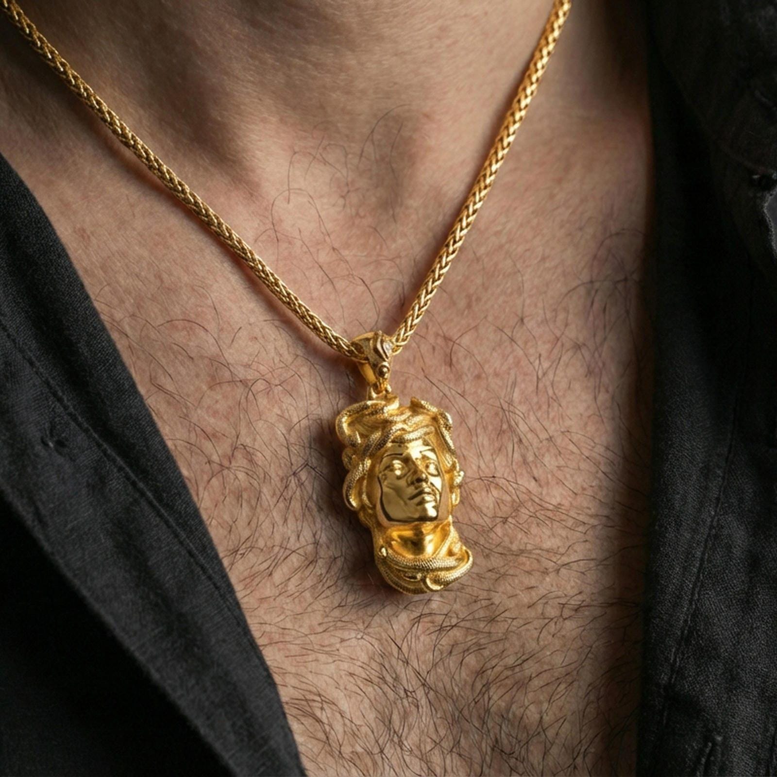 Gold plated Medusa head pendant necklace worn on the neck, lifestyle wear photo with warm tone shine and bold statement pendant presence.