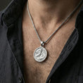 Load image into Gallery viewer, Polished silver round dragon coin pendant necklace worn on the neck, clean lifestyle wear shot capturing bright reflections and the detailed dragon motif.
