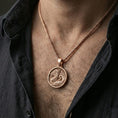 Load image into Gallery viewer, Rose gold plated round dragon coin pendant necklace worn on the neck, lifestyle wear shot with elegant rosy shine and high-relief dragon texture visible.
