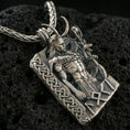 Load image into Gallery viewer, Oxidized Loki pendant necklace on textured volcanic rock, close-up centered shot highlighting the horned figure, staff, and deep antique shadowing.
