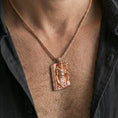 Load image into Gallery viewer, Rose gold plated Loki pendant necklace worn on the neck, lifestyle wear shot featuring elegant rosy shine and clear rune-and-knotwork detail.

