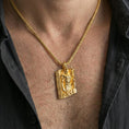 Load image into Gallery viewer, Gold plated Loki pendant necklace worn on the neck, lifestyle photo with warm tone finish and strong statement pendant presence.
