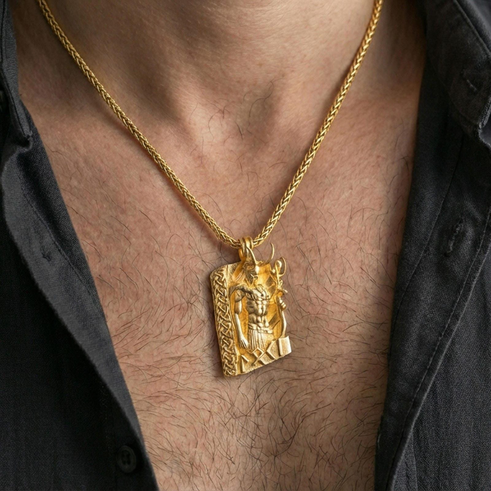Gold plated Loki pendant necklace worn on the neck, lifestyle photo with warm tone finish and strong statement pendant presence.