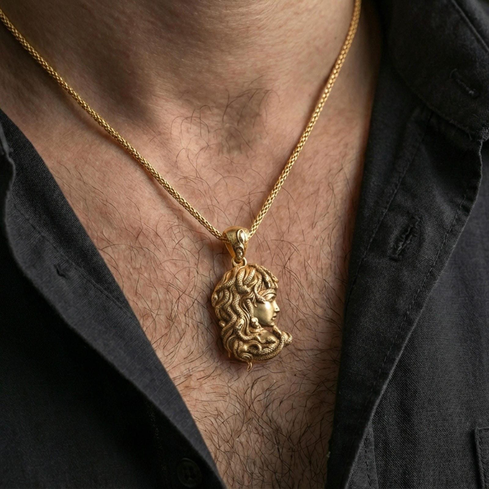 Gold plated Medusa profile pendant necklace worn on the neck, lifestyle photo featuring warm tone finish and strong statement medallion presence.
