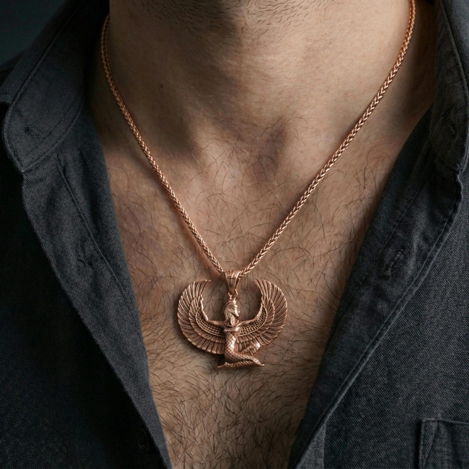 Rose gold plated winged goddess Isis pendant necklace worn on the neck, lifestyle wear shot with elegant rosy shine and crisp wing-and-figure detailing.
