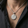 Load image into Gallery viewer, Polished silver dragon medallion pendant necklace worn on the neck, clean lifestyle wear shot capturing bright reflections and the detailed dragon relief in natural light.
