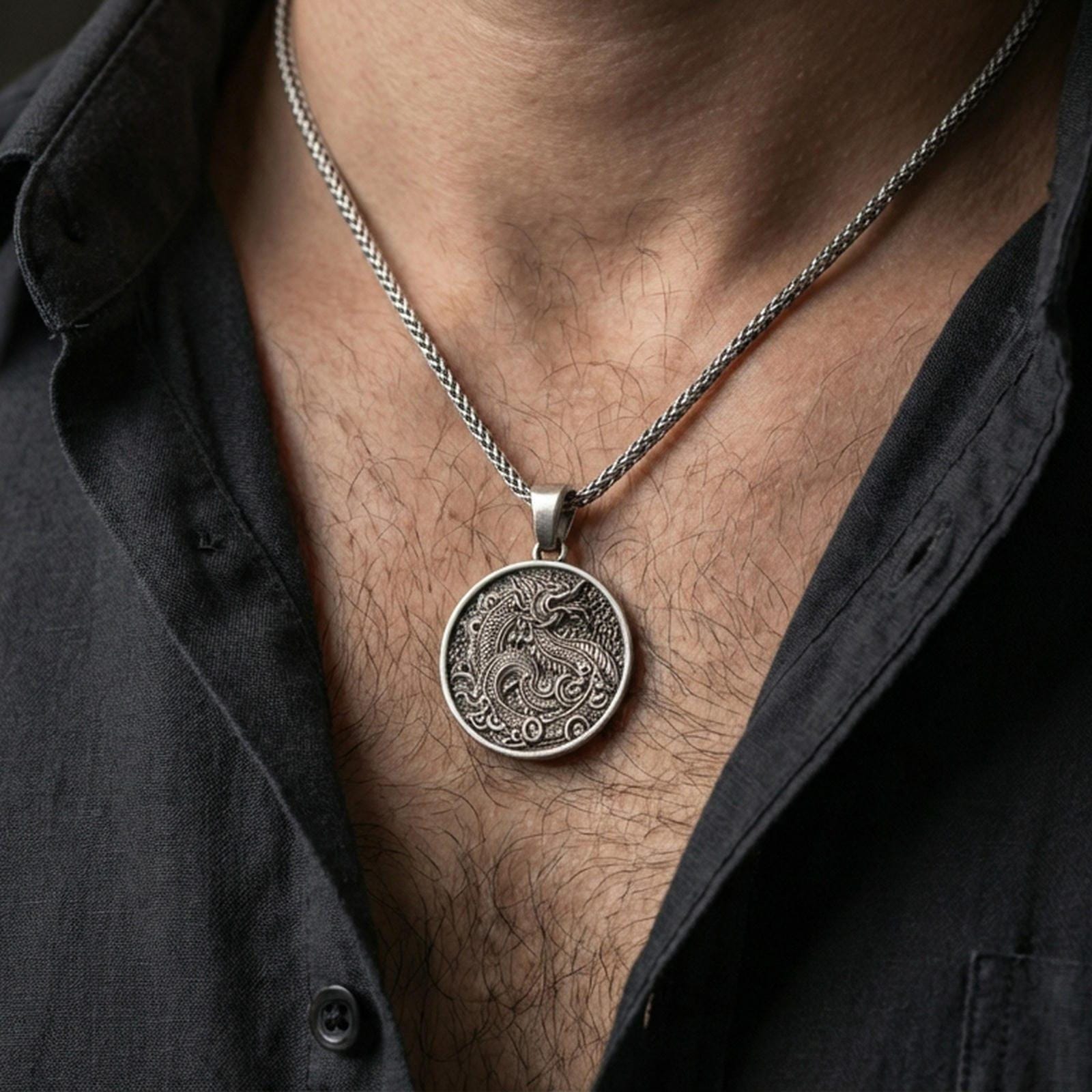 Oxidized dragon medallion pendant necklace worn on the neck, lifestyle framing showing realistic scale and bold vintage contrast against the chest.