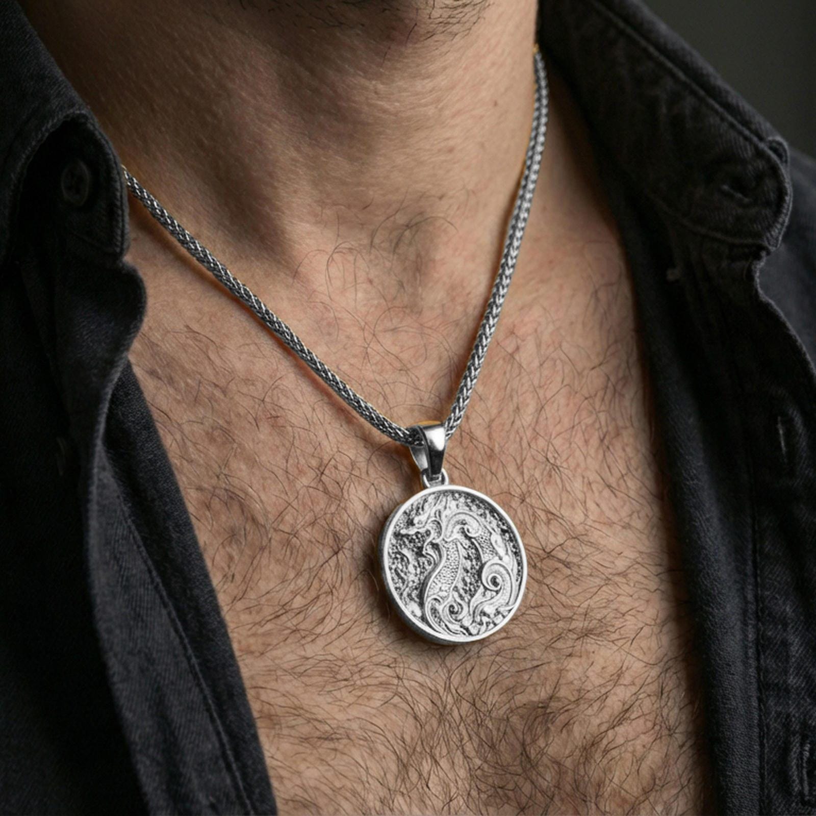 Polished silver dragon medallion pendant necklace worn on the neck, clean lifestyle wear shot capturing bright reflections and the detailed dragon engraving in natural light.