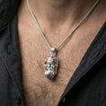 Load image into Gallery viewer, Polished silver Odin pendant necklace worn on the neck, clean lifestyle wear shot capturing bright shine and the detailed one-eyed warrior portrait in natural light.
