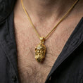 Load image into Gallery viewer, Gold plated Odin pendant necklace worn on the neck, lifestyle photo featuring warm tone finish and strong statement pendant presence.
