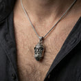 Load image into Gallery viewer, Oxidized Odin pendant necklace worn on the neck, lifestyle framing showing realistic scale and bold vintage contrast against the chest.
