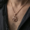 Load image into Gallery viewer, Rose gold plated griffin pendant necklace worn on the neck, lifestyle wear shot with elegant rosy shine and crisp wing-and-lion detailing visible.
