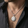 Load image into Gallery viewer, Polished silver Spartan shield medallion pendant necklace worn on the neck, clean lifestyle wear shot capturing bright shine and the engraved Greek key motif in natural light.
