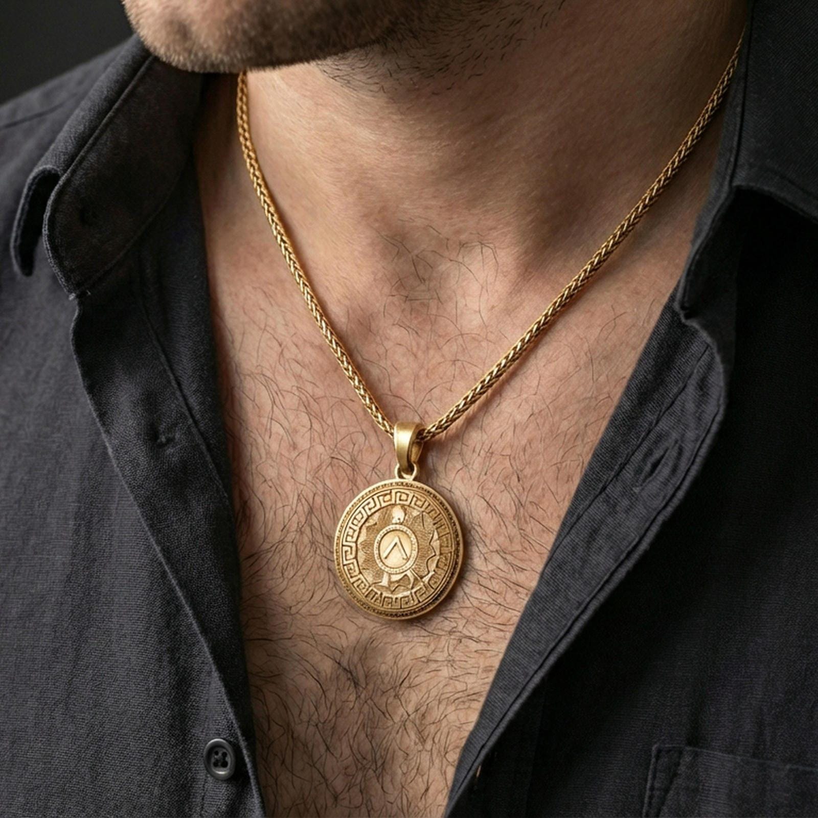 Gold plated Spartan shield medallion pendant necklace worn on the neck, lifestyle photo featuring warm tone finish and strong statement warrior medallion presence.