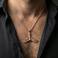 Load image into Gallery viewer, Rose gold plated winged goddess ankh pendant necklace worn on the neck, lifestyle wear shot with elegant rosy shine and crisp wing-and-figure detailing visible.
