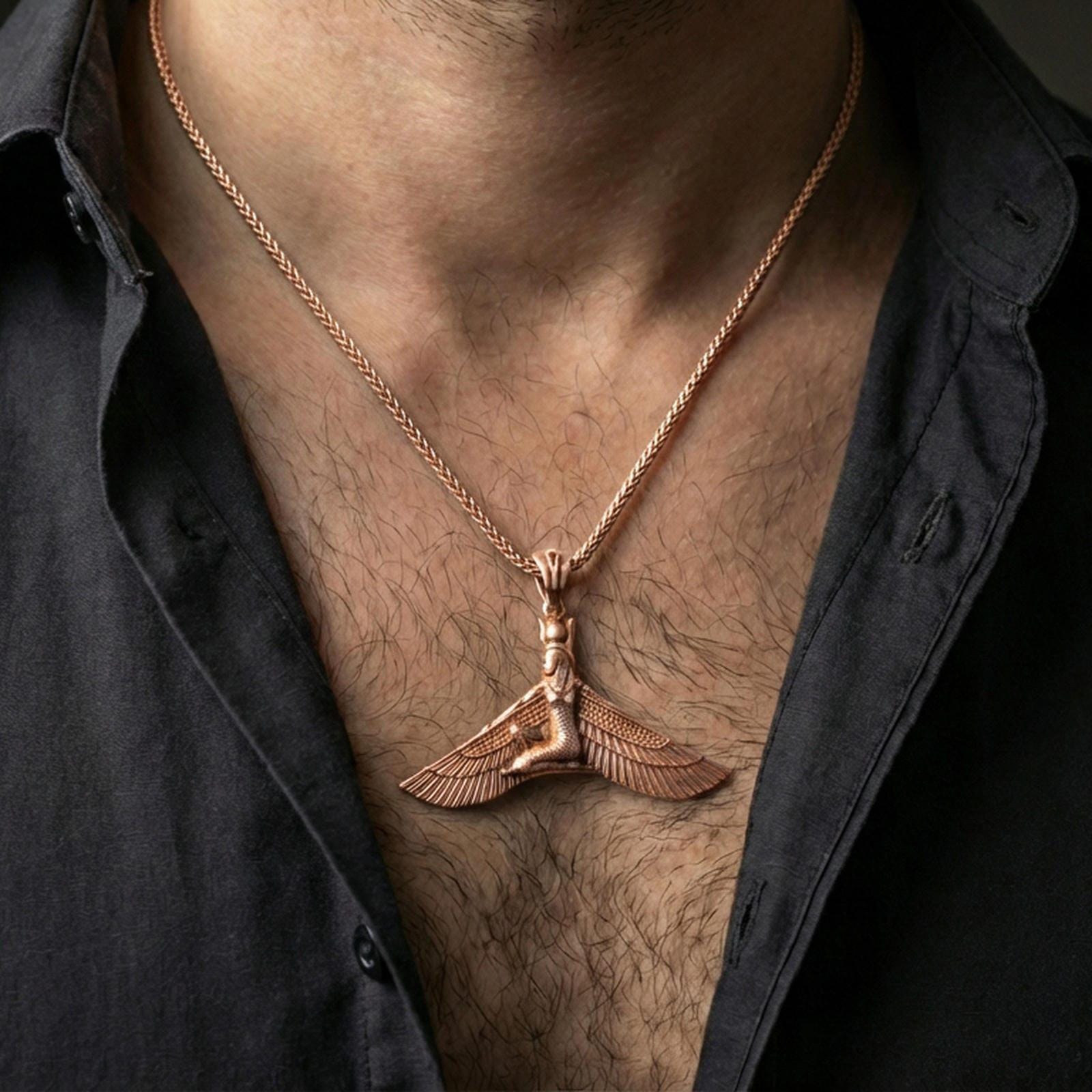 Rose gold plated winged goddess ankh pendant necklace worn on the neck, lifestyle wear shot with elegant rosy shine and crisp wing-and-figure detailing visible.