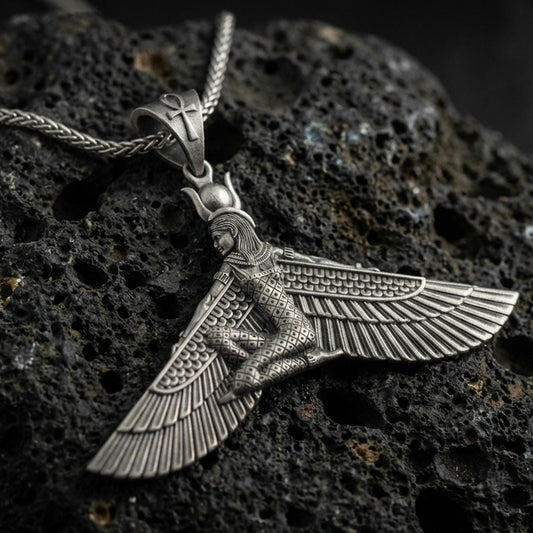 Oxidized winged goddess ankh pendant necklace on textured volcanic rock, centered close-up highlighting the spread wings, ankh bale detail, and deep antique shadowed contrast.
