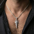 Load image into Gallery viewer, Polished silver Gungnir spear pendant necklace worn on the neck, clean lifestyle wear shot capturing bright shine and the detailed spearhead design in natural light.
