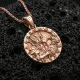 Load image into Gallery viewer, Rose gold plated Odin and raven medallion pendant necklace on textured volcanic rock, centered studio-style close-up showcasing soft rosy glow and intricate Norse mythology detailing.
