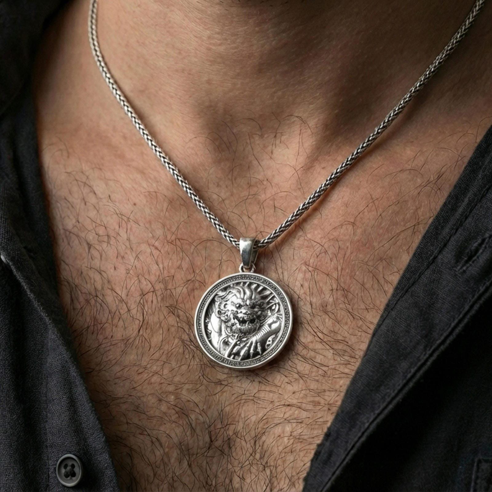 Polished silver imperial guardian lion pendant necklace worn on the neck, clean lifestyle wear shot capturing bright shine and the detailed lion relief in natural light.