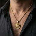 Load image into Gallery viewer, Gold plated Heracles lion helmet coin pendant necklace worn on the neck, lifestyle photo featuring warm tone finish and strong statement medallion presence.
