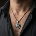 Load image into Gallery viewer, Oxidized Heracles lion helmet coin pendant necklace worn on the neck, lifestyle framing showing realistic scale and bold vintage contrast against the chest.

