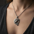 Load image into Gallery viewer, Oxidized Athena warrior pendant necklace worn on the neck, lifestyle framing showing realistic scale and bold vintage contrast against the chest.
