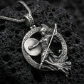 Load image into Gallery viewer, Oxidized Athena warrior pendant necklace on textured volcanic rock, centered close-up highlighting the Greek key frame, helmeted goddess figure, spear, and deep antique shadowed contrast.
