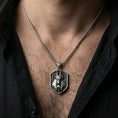 Load image into Gallery viewer, Oxidized Anubis pendant necklace worn on the neck, lifestyle framing showing realistic scale and bold vintage contrast against the chest.
