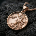 Load image into Gallery viewer, Rose gold plated koi fish medallion pendant necklace on textured volcanic rock, centered studio-style close-up showcasing soft rosy glow and intricate koi-and-wave detailing with a refined finish.
