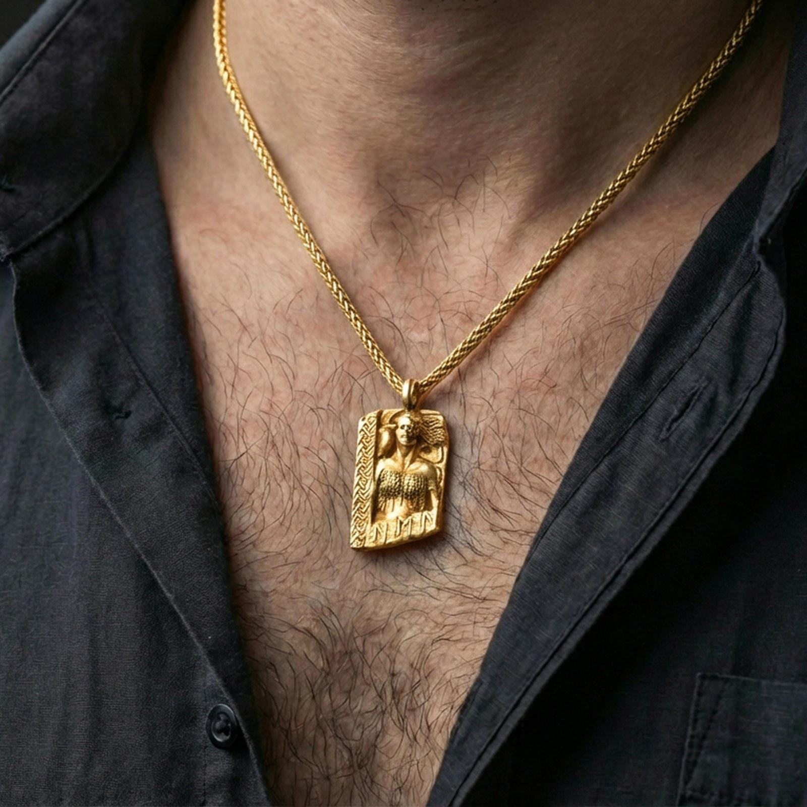 Gold plated Hel Norse goddess pendant necklace worn on the neck, lifestyle photo featuring warm tone finish and strong statement Viking amulet presence.