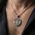 Load image into Gallery viewer, Oxidized Yggdrasil tree of life pendant necklace worn on the neck, lifestyle framing showing realistic scale and bold vintage contrast against the chest.

