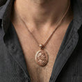Load image into Gallery viewer, Rose gold plated Hades coin pendant necklace worn on the neck, lifestyle wear shot with elegant rosy shine and crisp Greek key border detailing visible.

