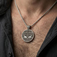 Load image into Gallery viewer, Oxidized Viking deer medallion pendant necklace worn on the neck, lifestyle framing showing realistic scale and bold vintage contrast against the chest.
