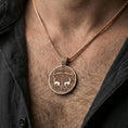 Load image into Gallery viewer, Rose gold plated Viking deer medallion pendant necklace worn on the neck, lifestyle wear shot with elegant rosy shine and crisp deer-and-scroll detailing visible.
