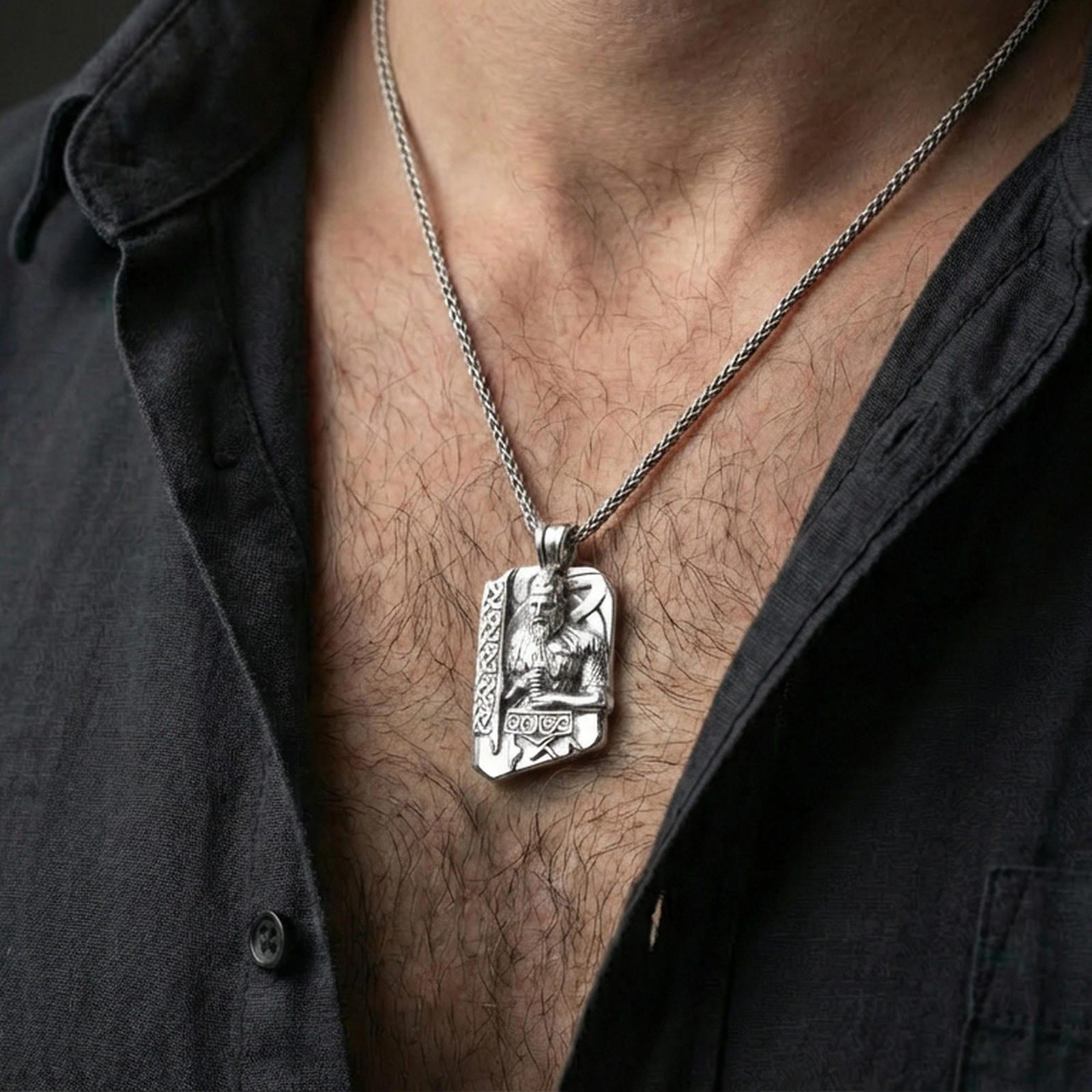 Polished silver Thor pendant necklace worn on the neck, clean lifestyle wear shot capturing bright shine and the detailed Norse god-and-hammer relief in natural light.