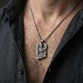 Load image into Gallery viewer, Oxidized Thor pendant necklace worn on the neck, lifestyle framing showing realistic scale and bold vintage contrast against the chest.

