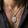 Load image into Gallery viewer, Polished silver griffin shield pendant necklace worn on the neck, clean lifestyle wear shot capturing bright shine and the detailed gryphon relief in natural light.
