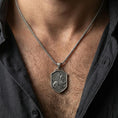 Load image into Gallery viewer, Oxidized griffin shield pendant necklace worn on the neck, lifestyle framing showing realistic scale and bold vintage contrast against the chest.
