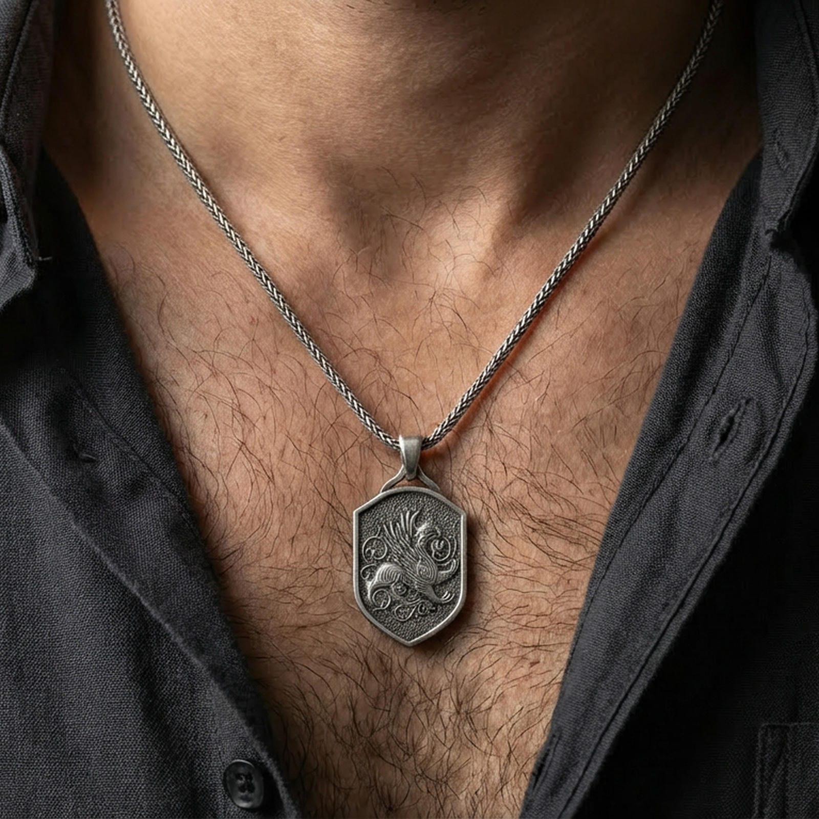 Oxidized griffin shield pendant necklace worn on the neck, lifestyle framing showing realistic scale and bold vintage contrast against the chest.