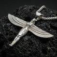 Load image into Gallery viewer, Polished silver winged Isis goddess pendant necklace on textured volcanic rock, crisp macro product photo emphasizing clean edges, sharp feather detailing, and bright reflective highlights on the figure.
