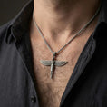 Load image into Gallery viewer, Oxidized winged Isis goddess pendant necklace worn on the neck, lifestyle framing showing realistic scale and bold vintage contrast against the chest.
