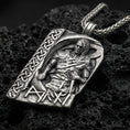 Load image into Gallery viewer, Oxidized Norse moon god pendant necklace on textured volcanic rock, centered close-up highlighting the seated deity relief, Celtic knot border, rune lettering, and deep antique shadowed contrast.
