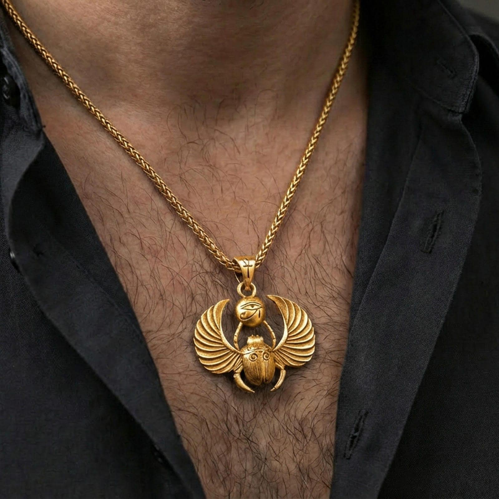 Gold plated winged scarab beetle pendant necklace worn on the neck, lifestyle photo featuring warm tone finish and strong statement Egyptian talisman presence.