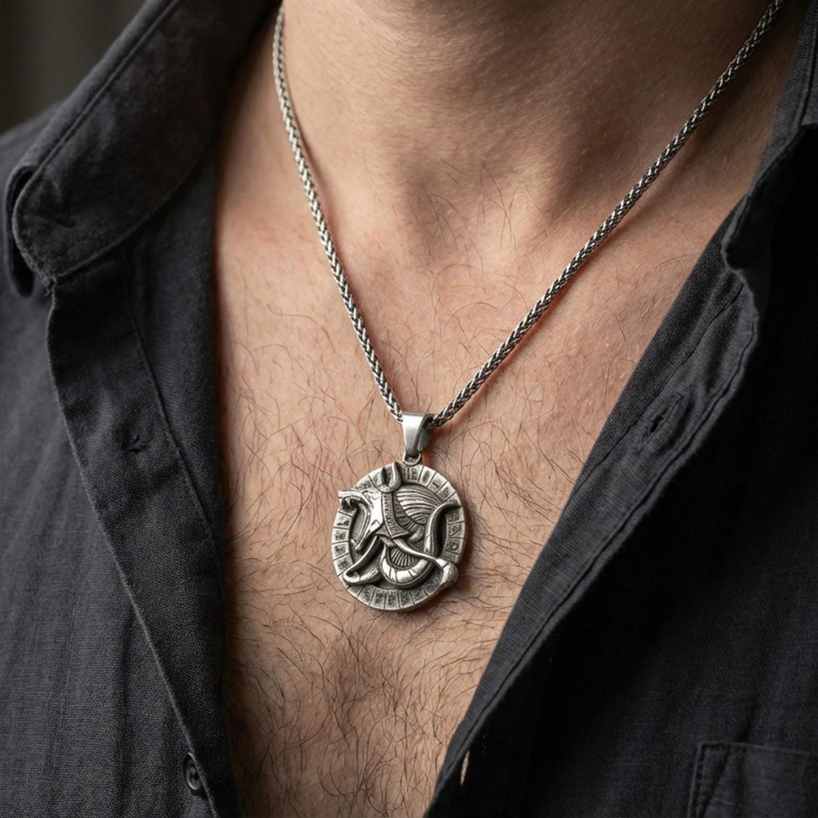 Oxidized Anubis medallion pendant necklace worn on the neck, lifestyle framing showing realistic scale and bold vintage contrast against the chest.