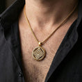 Load image into Gallery viewer, Gold plated geometric rune-style medallion pendant necklace worn on the neck, lifestyle photo featuring warm tone finish and strong statement talisman presence.
