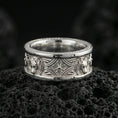 Load image into Gallery viewer, Polished silver fox band ring on textured volcanic rock, crisp macro product photo emphasizing clean edges, sharp relief detailing, and bright reflective highlights across the patterned band.
