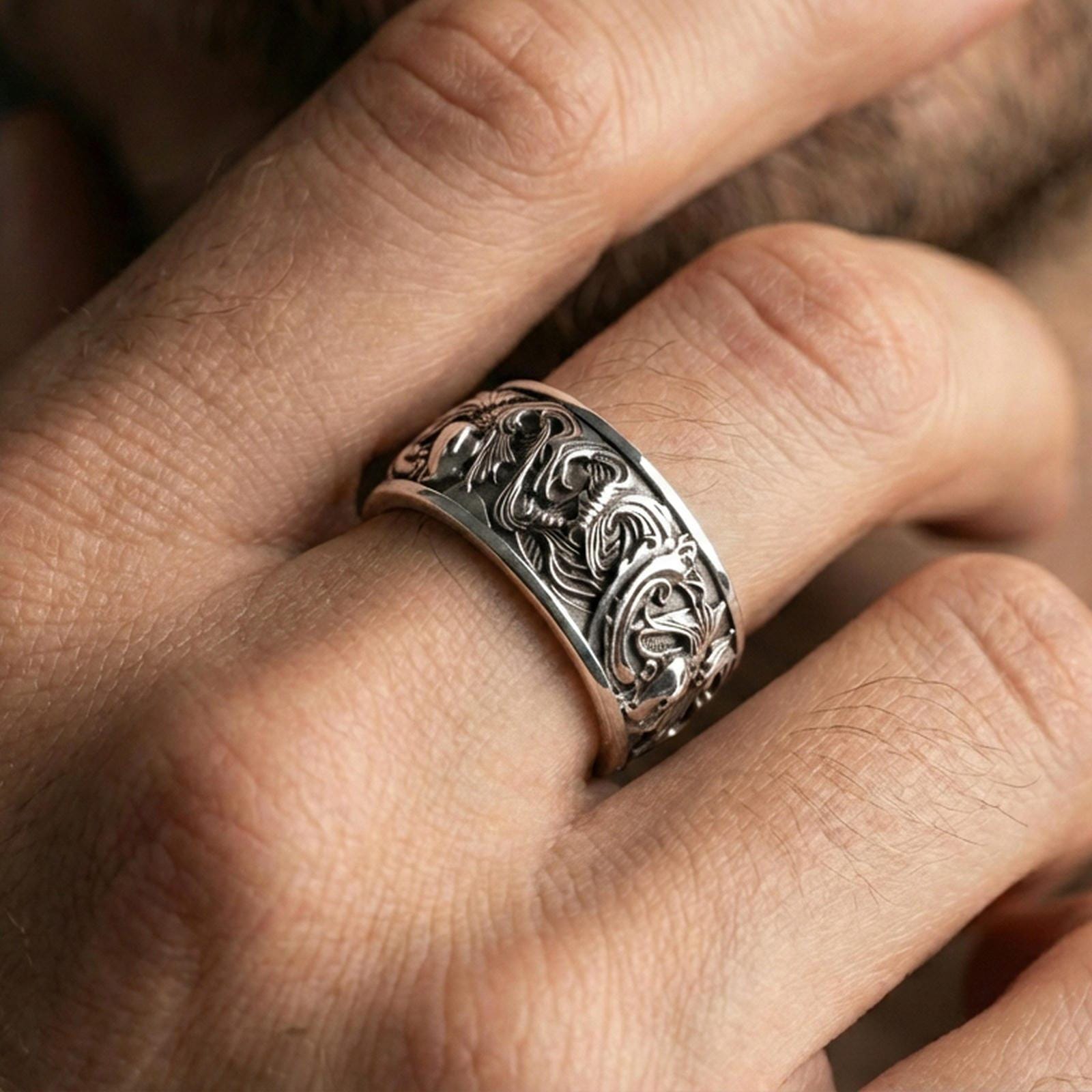 Polished silver koi fish band ring worn on a finger, clean lifestyle wear shot capturing bright shine and the detailed koi relief in natural light.