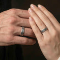 Load image into Gallery viewer, Oxidized Celtic knot band ring worn on a finger, lifestyle wear shot showing antique contrast and the continuous knot pattern at true scale.

